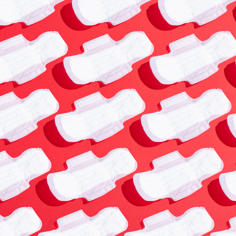 rows of menstrual pads against red backdrop