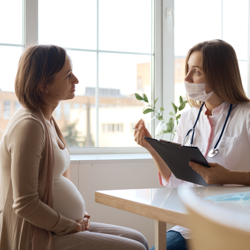pregnant person talking with doctor